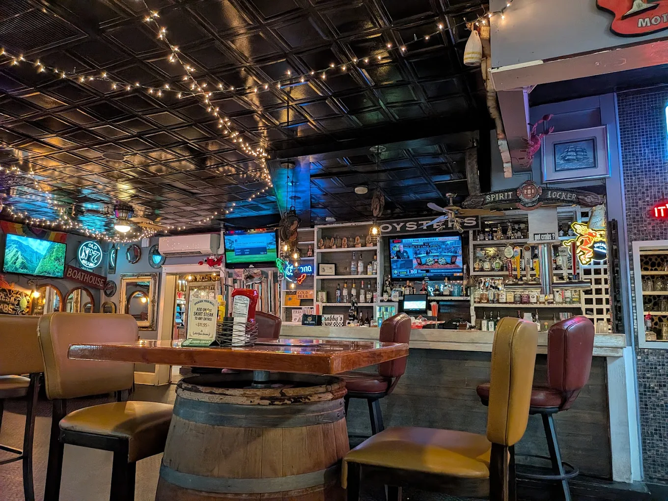 Cozy bar with string lights and TVs