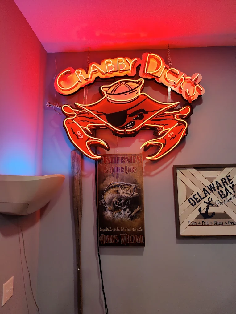 Iconic Crabby Dick's neon crab sign glowing red